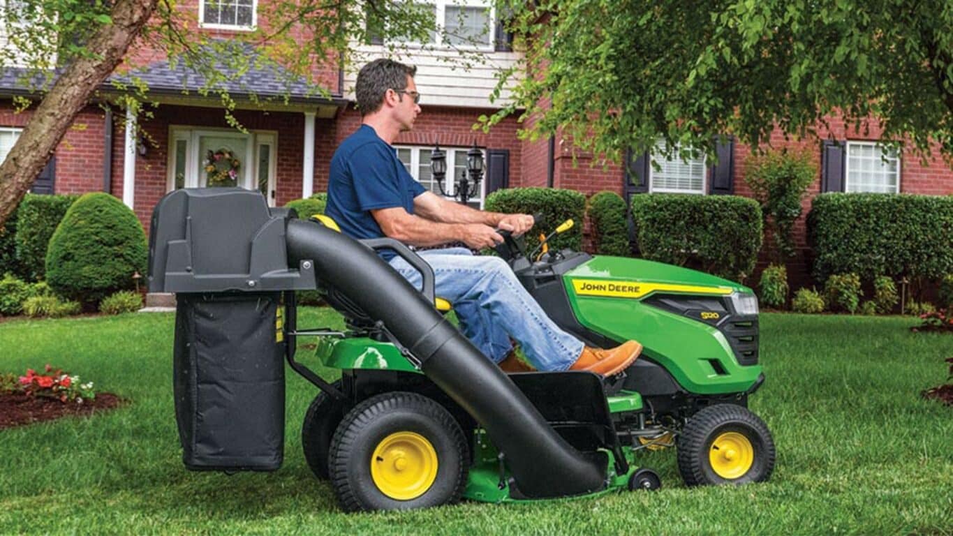 Person riding on a S120 mower using a bagger