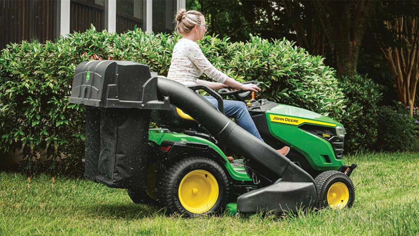 Person riding on a S180 mower using a bagger