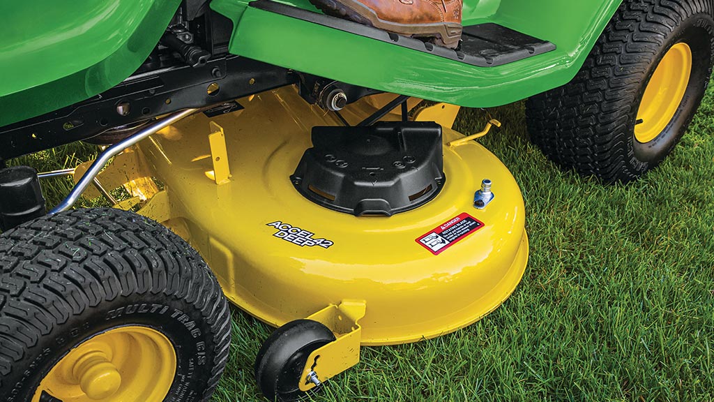 shot of mower going around a rock