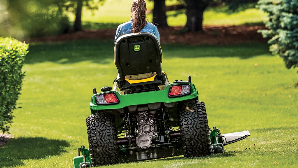 image of mower cutting around a bush