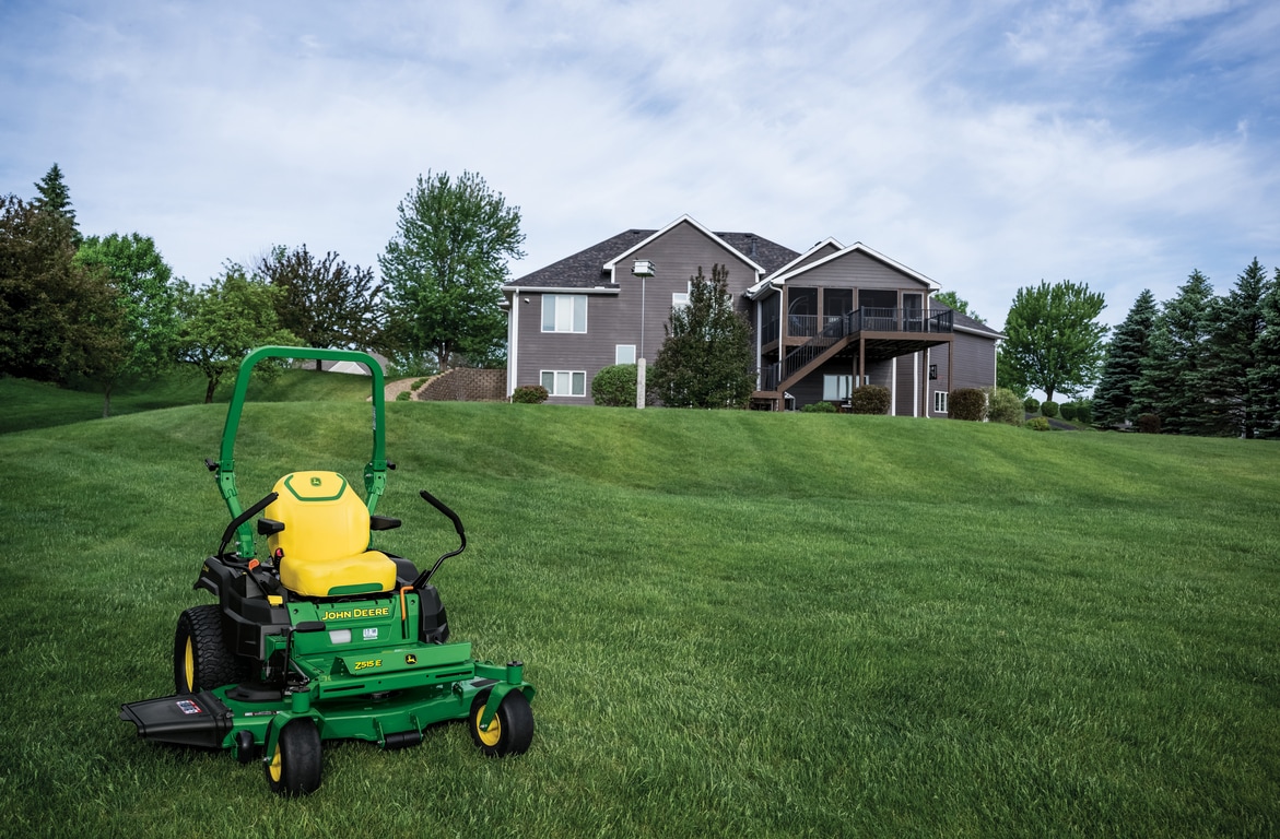 A Z515E zero-turn mower with a yellow seat rests on a well-kept lawn.