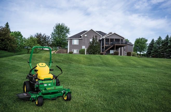 A Z515E zero-turn mower with a yellow seat rests on a well-kept lawn.