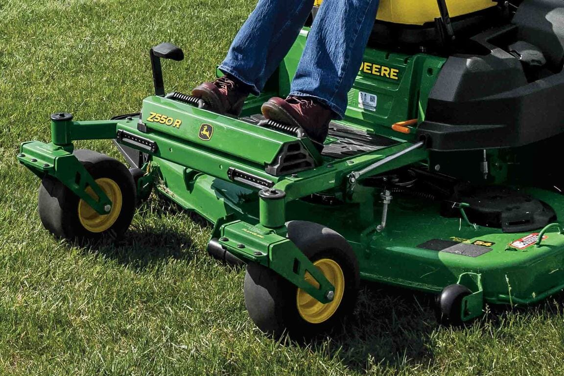 Close-up front-left-facing shot of a Z550R zero-turn mower deck and foot rest over grass.