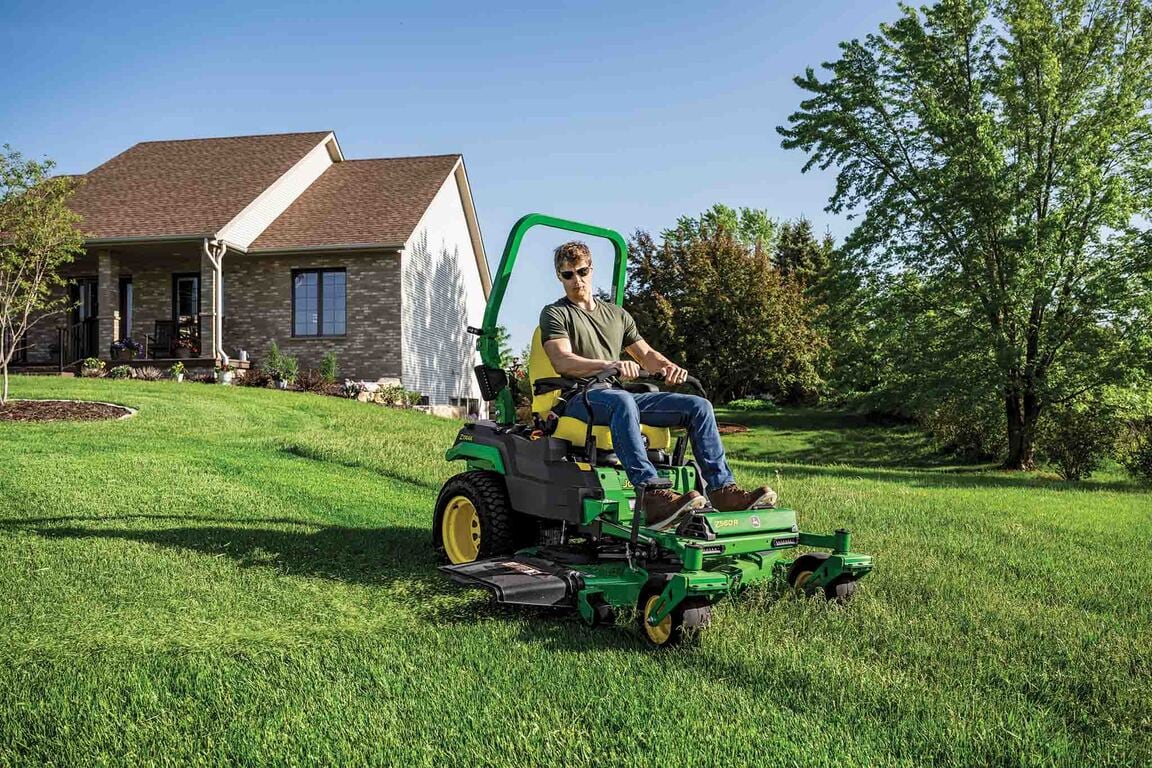 A Z560R zero-turn mower is used to mow the gentle sloped front lawn of a residence.