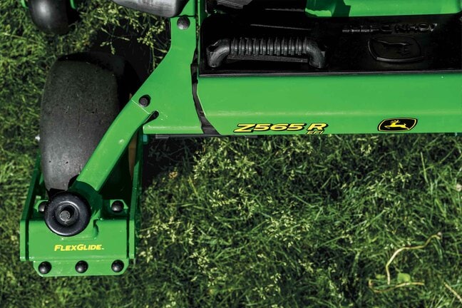 Close-up shot of the Z565R and FlexGlide logos on a zero-turn mower over grass.