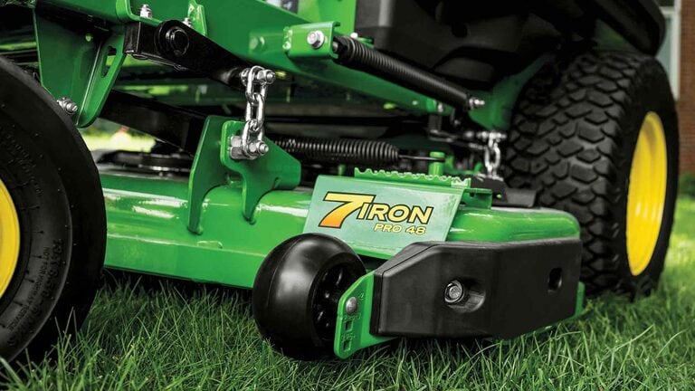 A zoomed-in shot of a green 7-iron PRO 48 inch deck on grass.