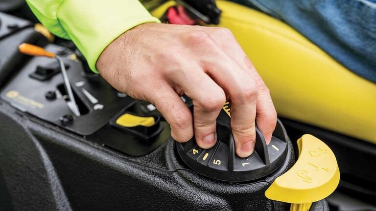 A zoomed-in shot of a landscaper’s hand operating the right-hand console of a Z740R zero-turn mower.