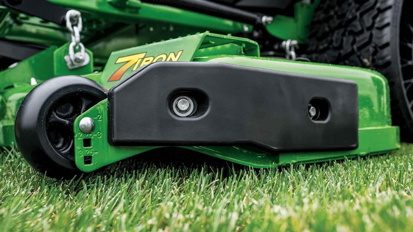 A close-up side shot of a green 7-iron deck for a zero-turn mower.