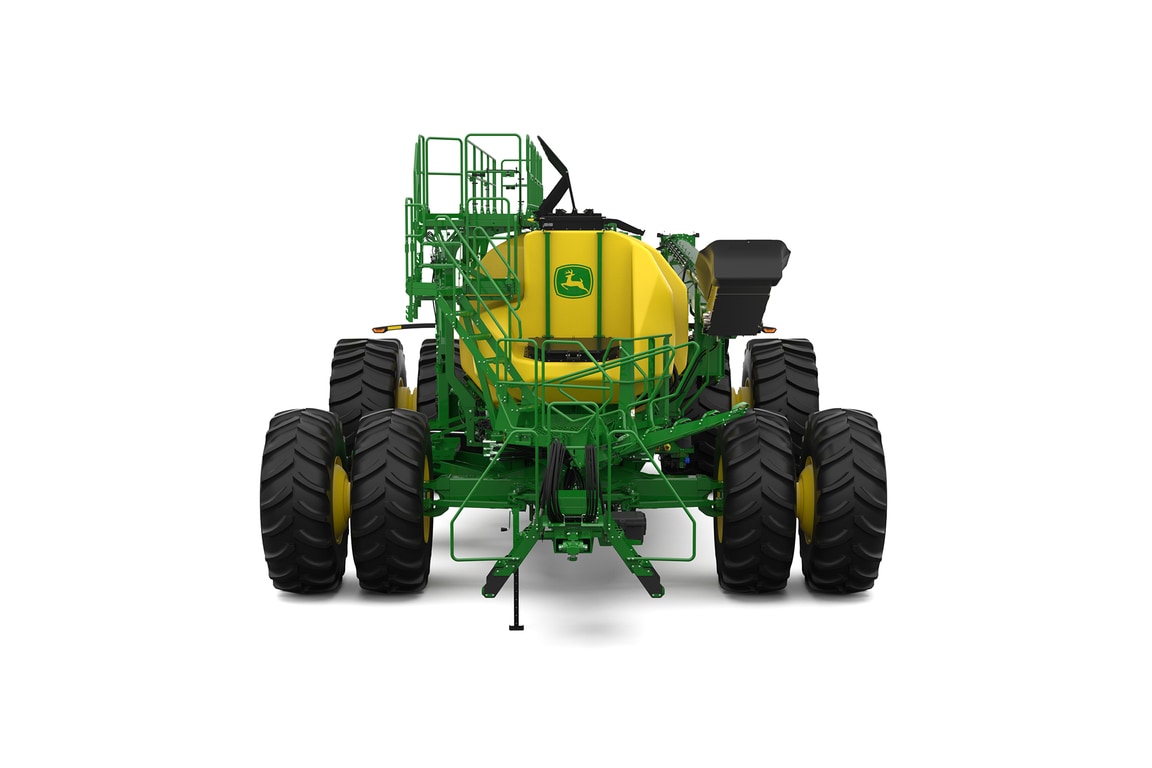 Front-facing studio shot of a green trailing air cart with yellow tanks on a white background.