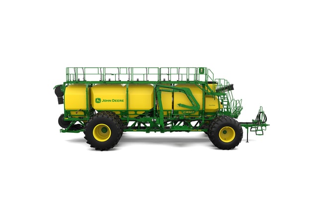 Right-facing studio shot of a green trailing air cart with yellow tanks on a white background.