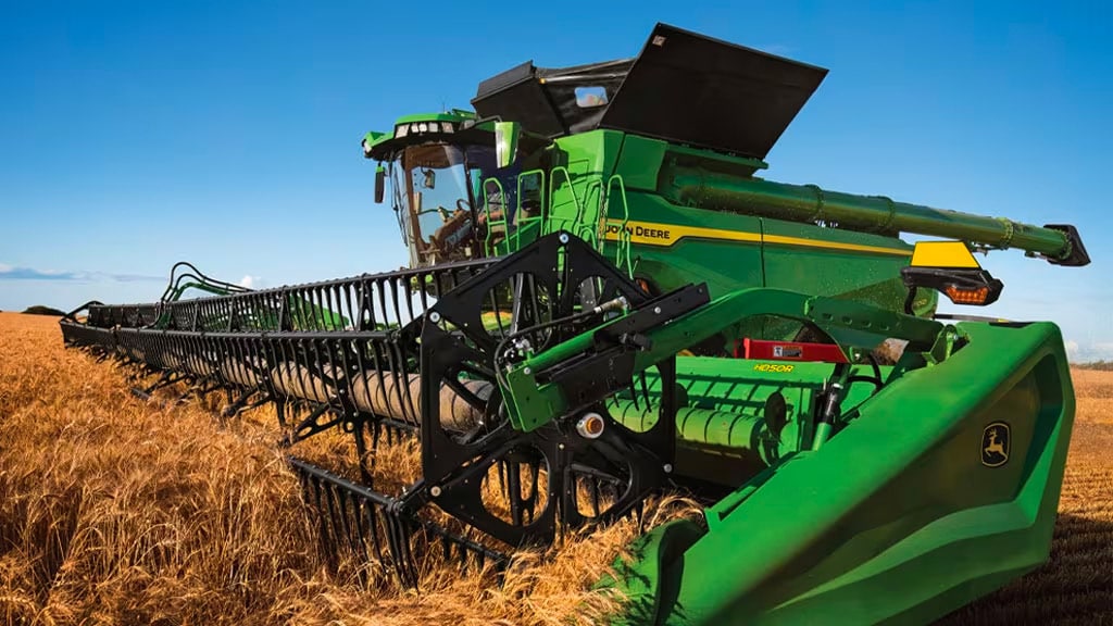 X9 Combine with Draper harvesting Wheat field