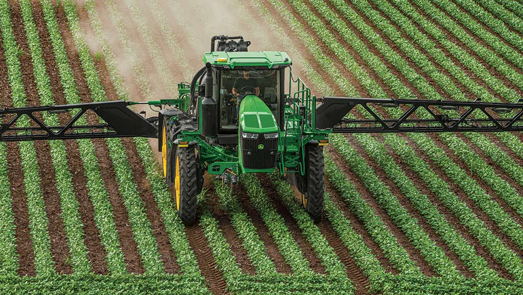 John Deere Sprayer working in row crop field.