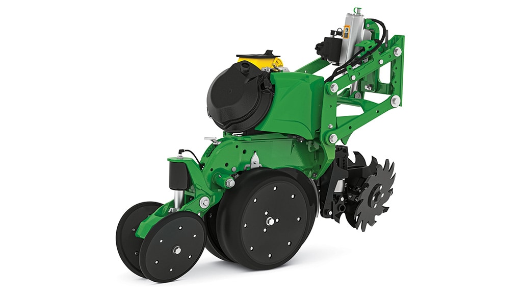 Studio image of a fully assembled John Deere ExactEmerge planter row unit, showing the green frame, closing wheels, row cleaners, and seed meter.