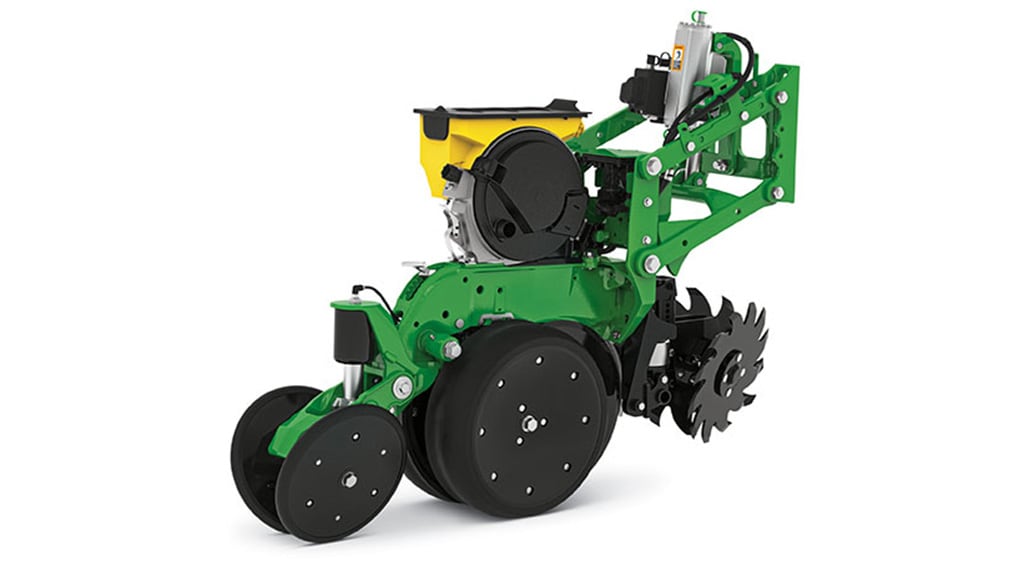 Studio image of a fully assembled John Deere MaxEmerge planter row unit, showing the green frame, yellow seed meter, closing wheels, and row cleaners.