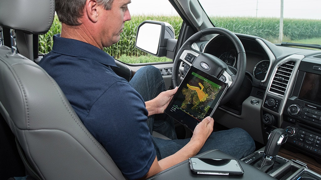 Image of person sitting in a truck looking at a tablet