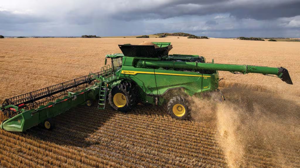 ohn Deere combine harvesting wheat.