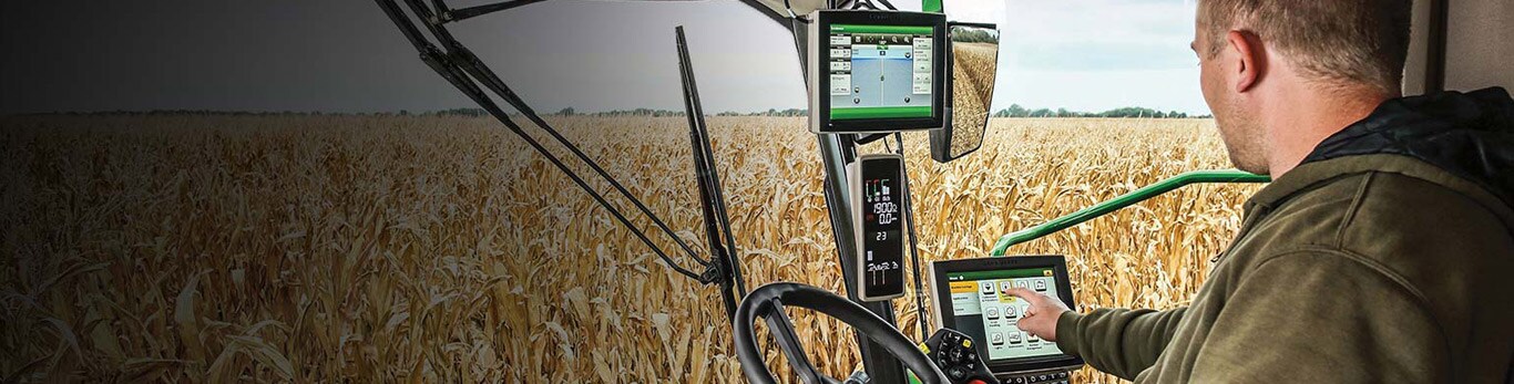 Farmer interacting with precision ag technology in tractor cab
