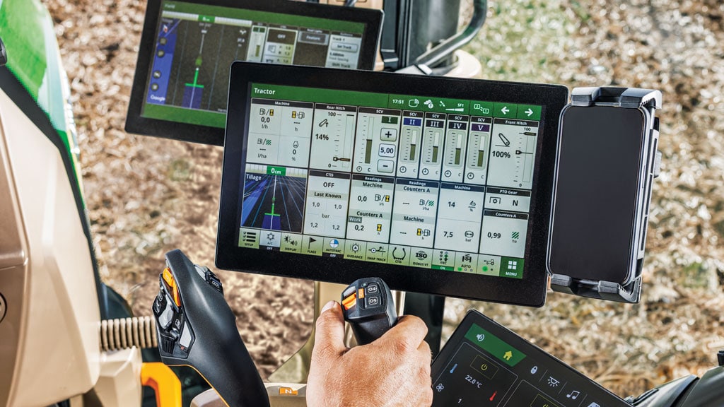 Interior cab view of CommandARM features like the CommandX controller and display screens.