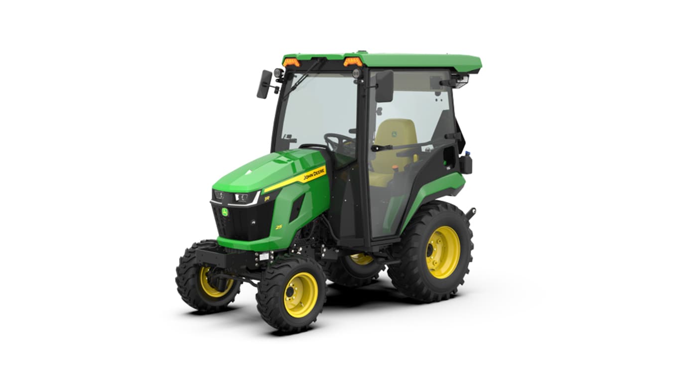Front-left-facing studio shot of a green HVAC cabbed compact tractor on a white background.