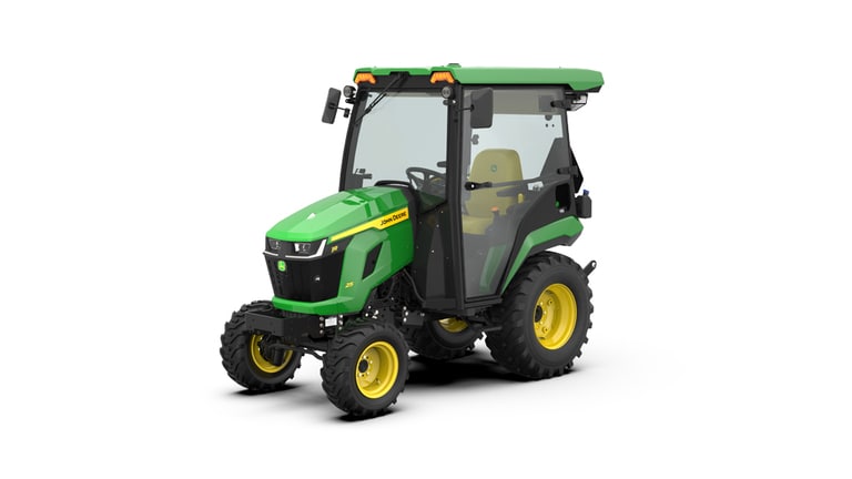Front-left-facing studio shot of a green HVAC cabbed compact tractor on a white background.