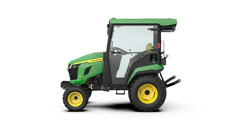 Left-facing studio shot of a green HVAC cabbed compact tractor on a white background.