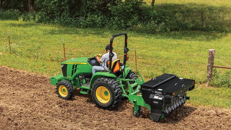 person tilling a field operating a 3039r
