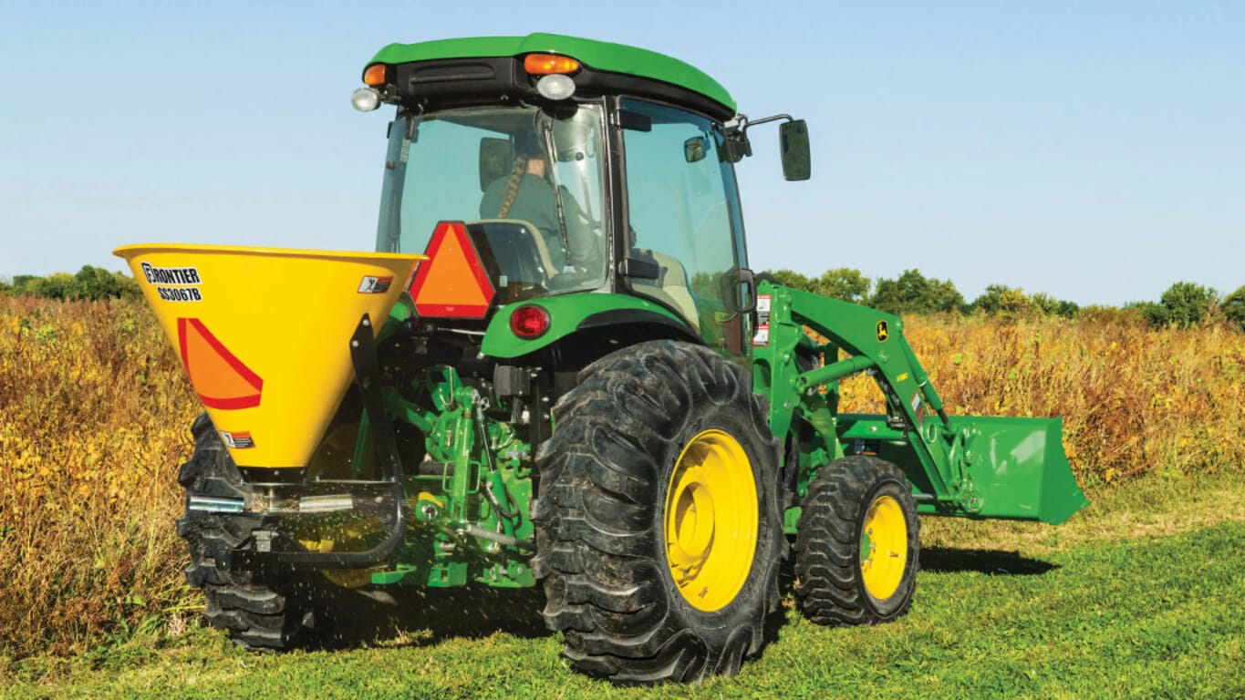 person operating a 4066r in a field with a rear attachment