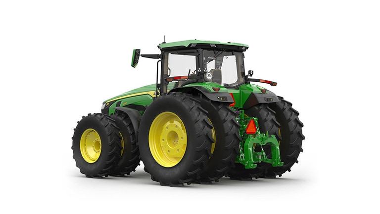 Rear-left-facing studio shot of a 16-wheeled green tractor on a white background.