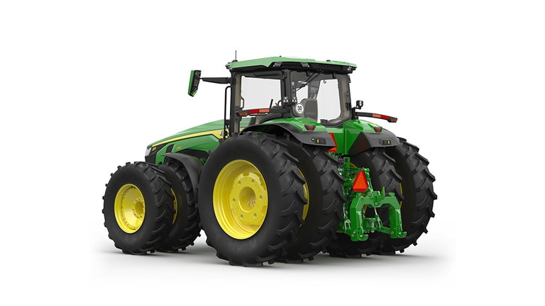 Rear-left-facing studio shot of a 16-wheeled green tractor on a white background.