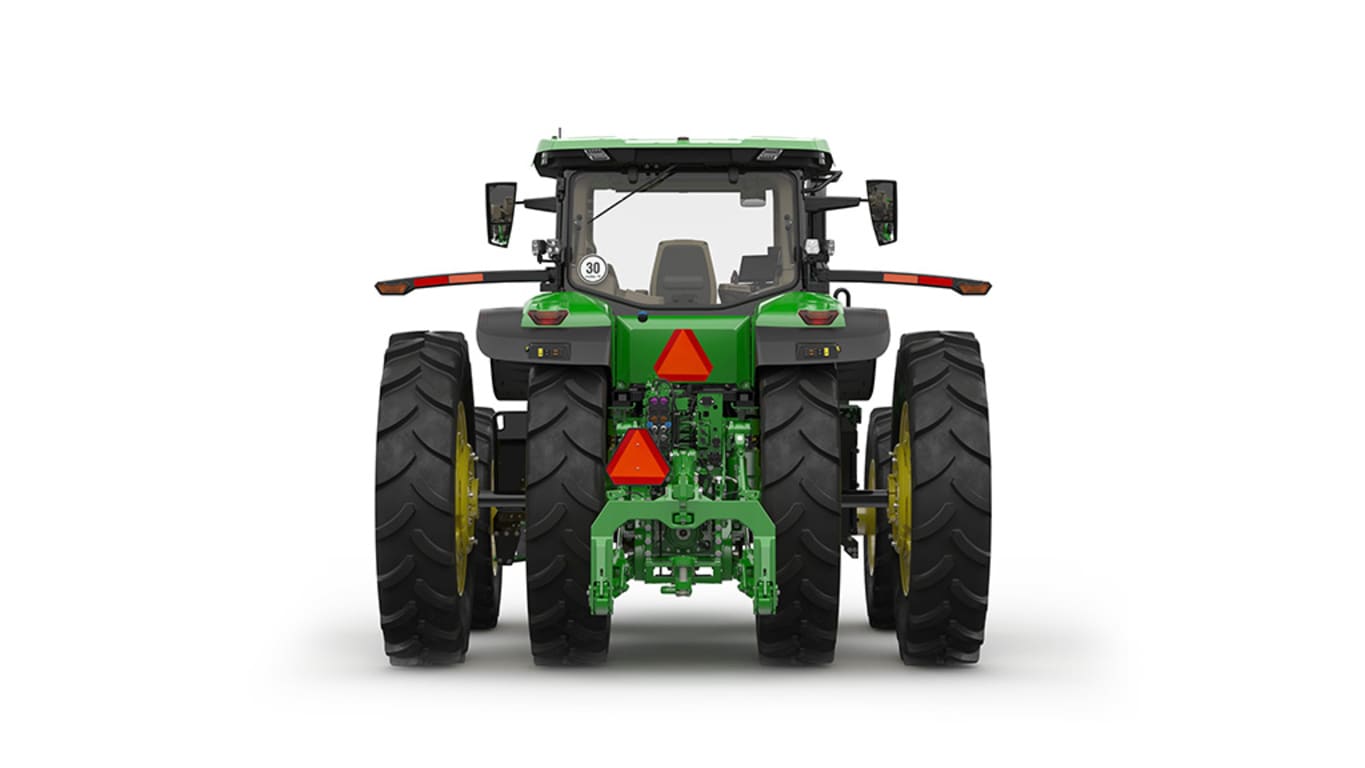 Rear-facing studio shot of a 16-wheeled green tractor on a white background.