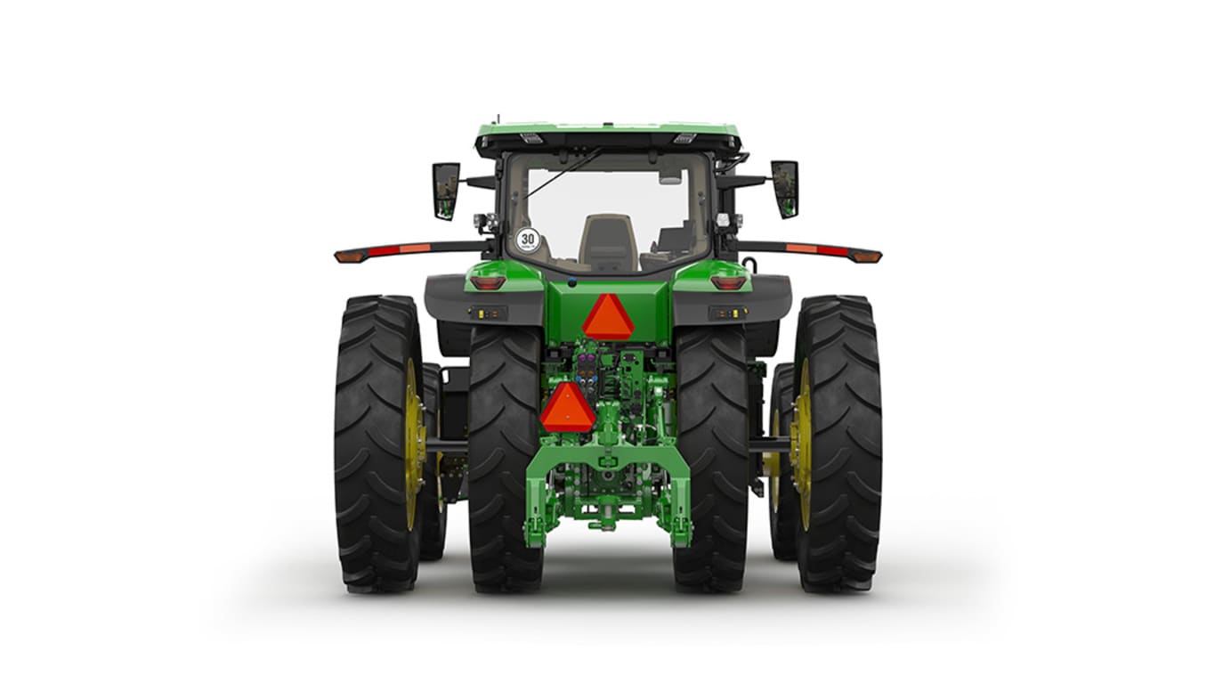 Image studio d'un tracteur vert à 16 roues vu de l'arrière sur fond blanc.