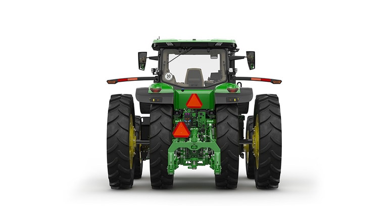 Image studio d'un tracteur vert à 16 roues vu de l'arrière sur fond blanc.