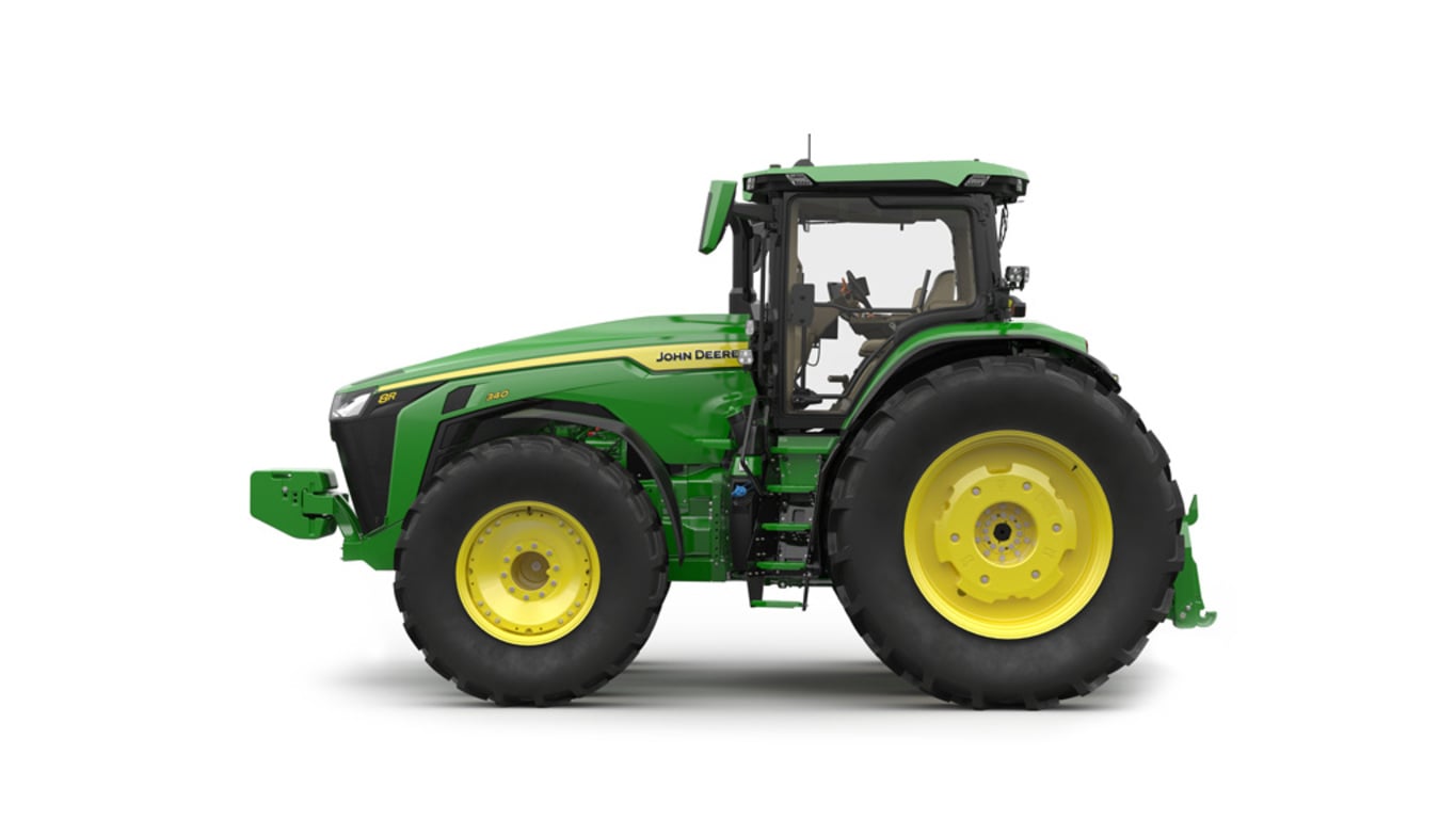 Left-facing studio shot of a 16-wheeled green tractor on a white background.