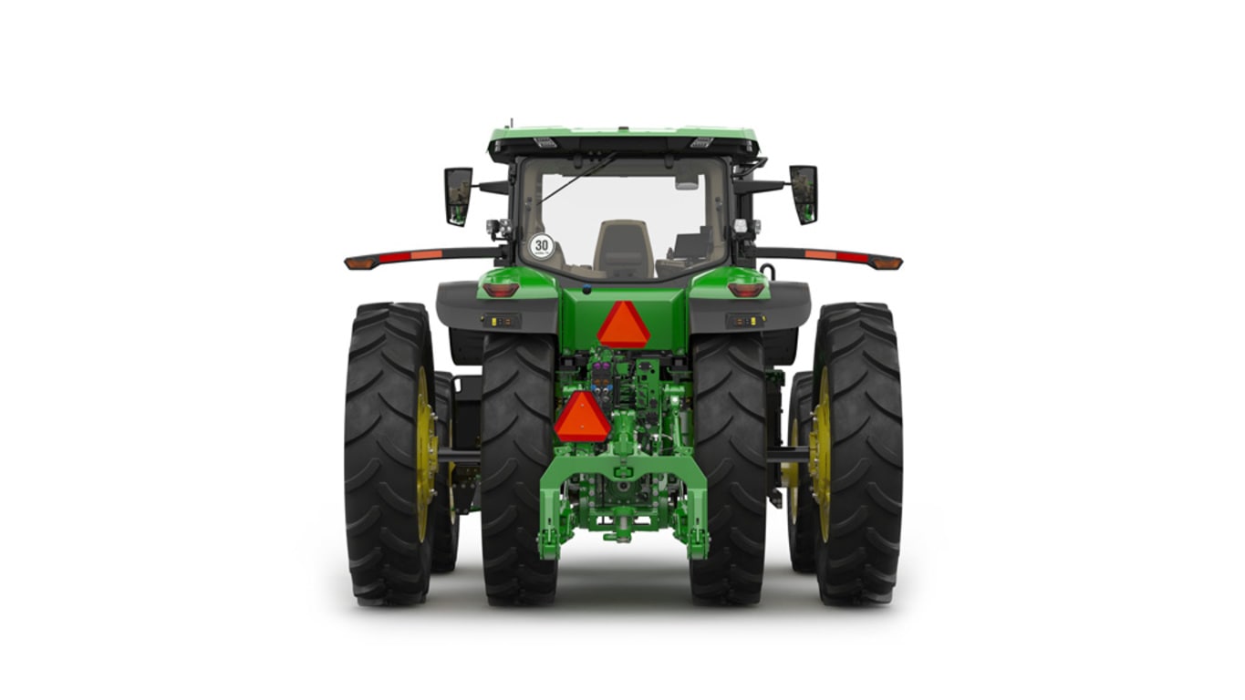 Rear-facing studio shot of a 16-wheeled green tractor on a white background.