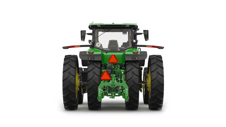 Rear-facing studio shot of a 16-wheeled green tractor on a white background.