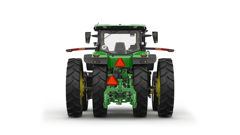 Rear-facing studio shot of a 16-wheeled green tractor on a white background.