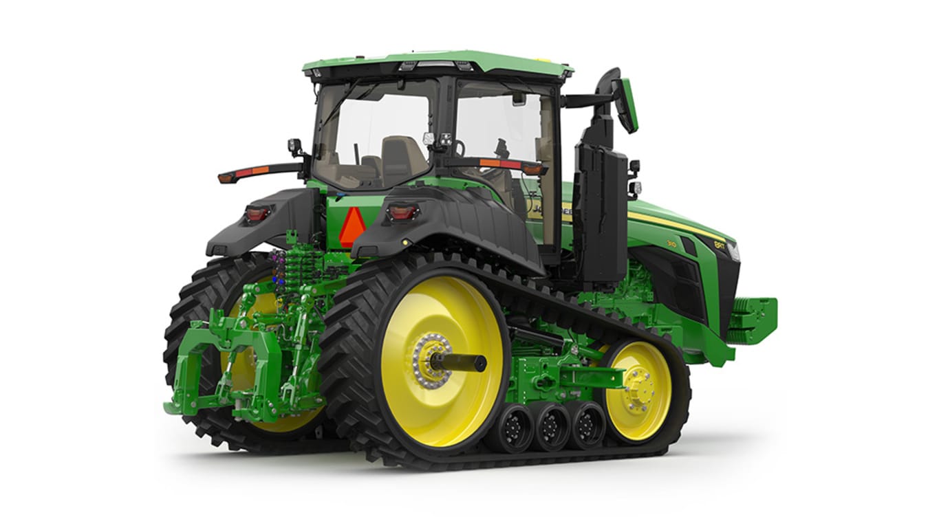 Rear-right-facing studio shot of a 2-tracked green tractor on a white background.