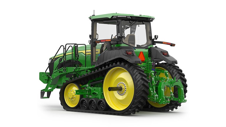Rear-left-facing studio shot of a 2-tracked green tractor on a white background.