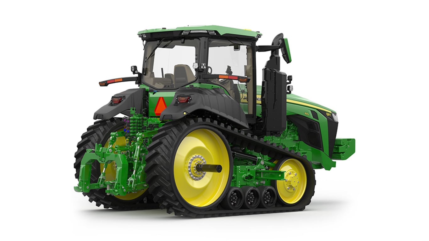 Rear-right-facing studio shot of a 2-tracked green tractor on a white background.