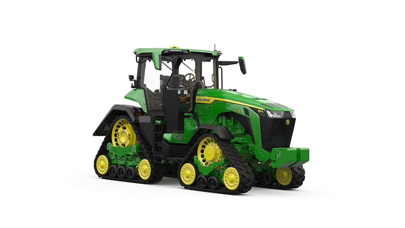 Image studio&nbsp;d'un tracteur vert&nbsp;à&nbsp;4&nbsp;chenilles vu de l'avant droit sur fond blanc.