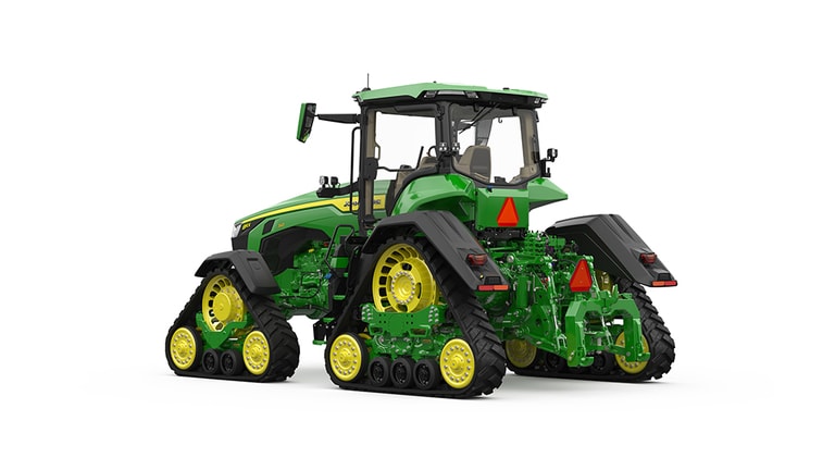 Rear-left-facing studio shot of a 4-tracked green tractor on a white background.