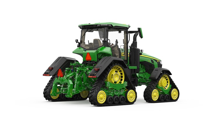 Rear-right-facing studio shot of a 4-tracked green tractor on a white background.