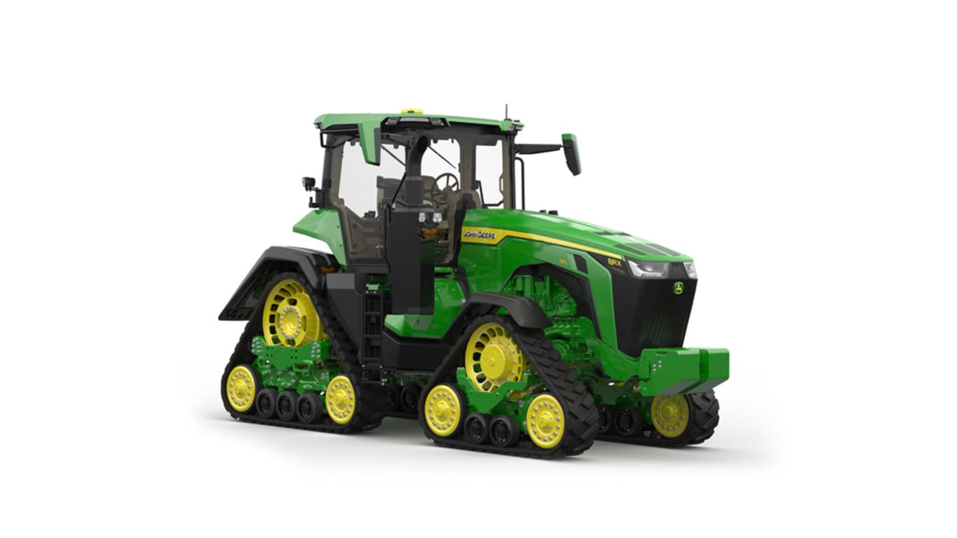 Image studio&nbsp;d'un tracteur vert&nbsp;à&nbsp;4&nbsp;chenilles vu de l'avant droit sur fond blanc.