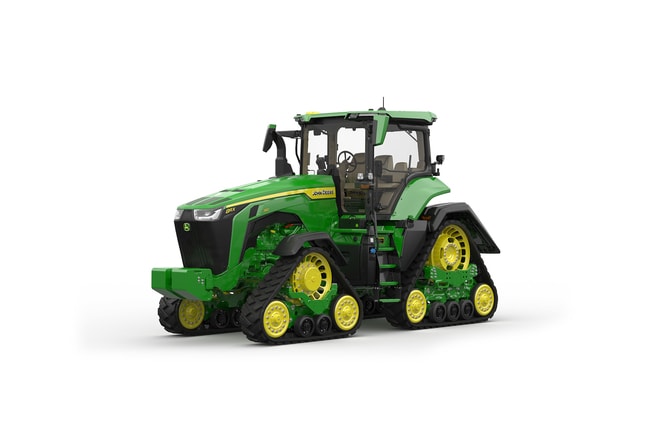 Image studio d'un tracteur vert à&nbsp;4&nbsp;chenilles vu de l'avant gauche sur fond blanc.