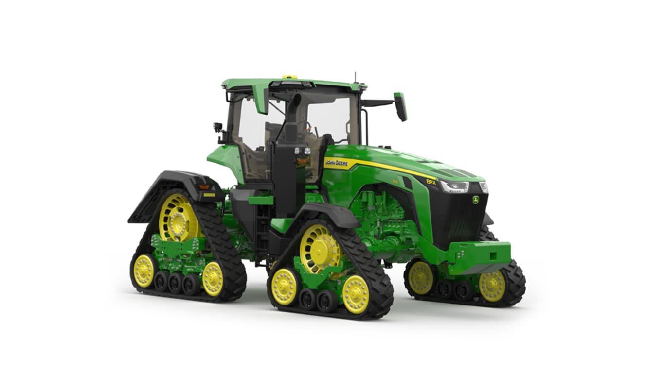 Image studio&nbsp;d'un tracteur vert&nbsp;à&nbsp;4&nbsp;chenilles vu de l'avant droit sur fond blanc.
