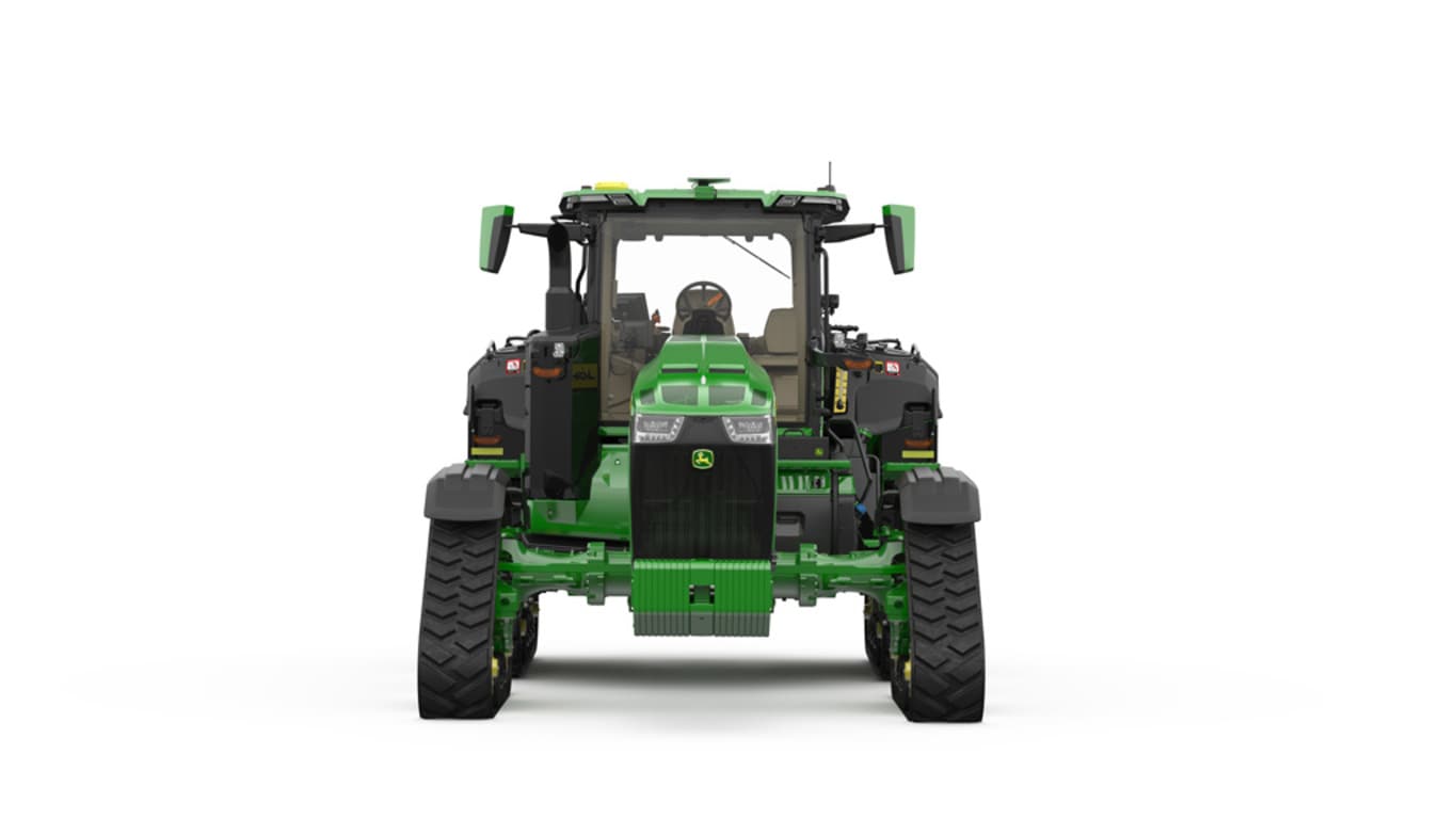 Image studio d'un tracteur vert à&nbsp;4&nbsp;chenilles vu de l'avant sur fond blanc.