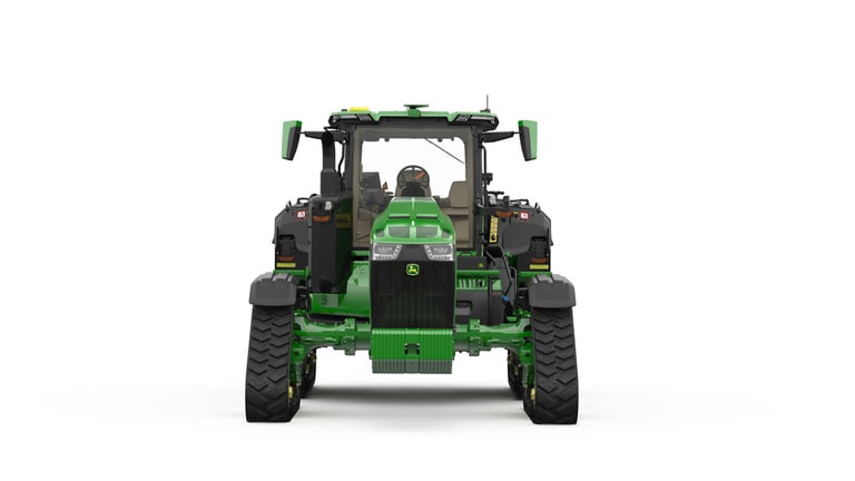 Image studio d'un tracteur vert à&nbsp;4&nbsp;chenilles vu de l'avant sur fond blanc.
