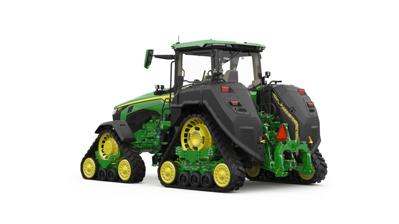 Rear-left-facing studio shot of a 4-tracked green tractor on a white background.
