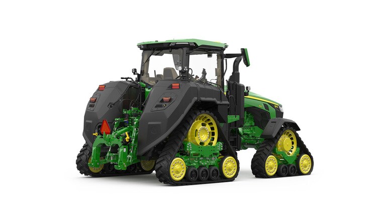 Rear-right-facing studio shot of a 4-tracked green tractor on a white background.