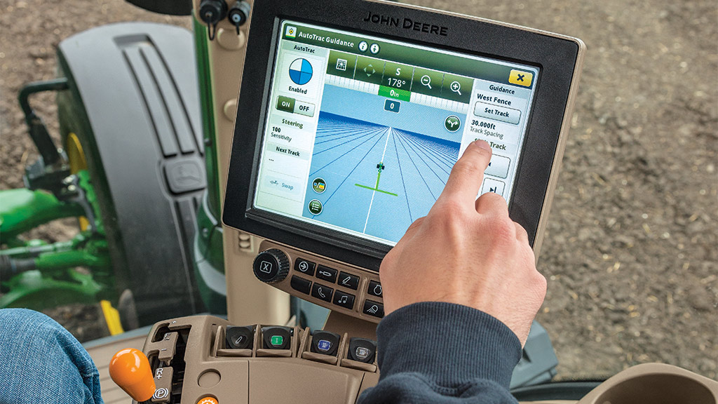 AutoTrac™ touchscreen being pressed